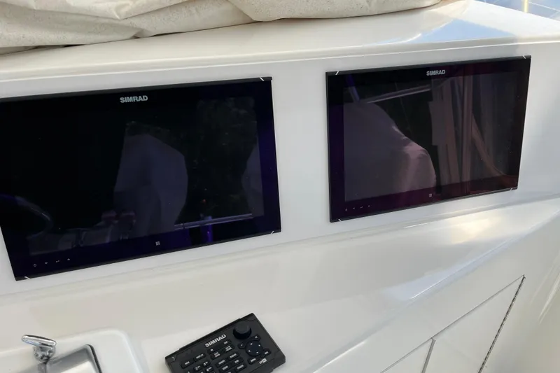 Slide: The Image of Dual Simrad displays on 1997 Post Sportfish boat dashboard. - 53