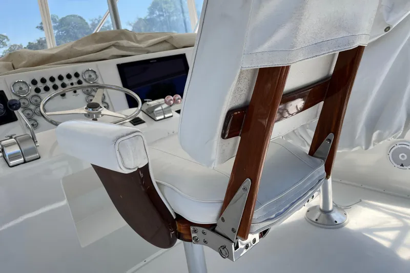 Slide: The Image of Captain's chair and helm of a 1997 Post Sportfish boat, featuring classic controls and gauges. - 56