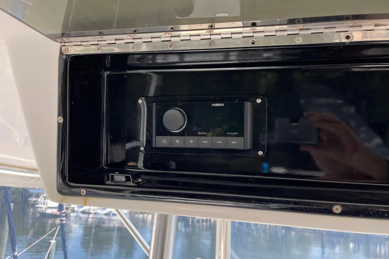 Slide: The Image of 1997 Post Sportfish boat with Fusion stereo system in black compartment. - 61