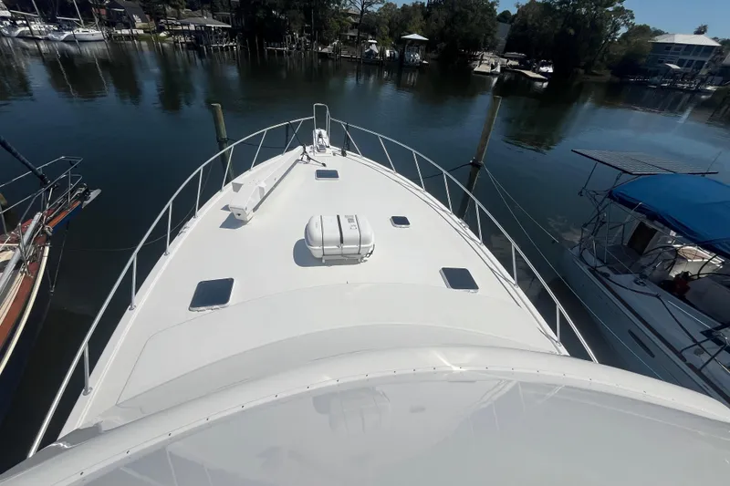 Slide: The Image of 1997 Post Sportfish boat docked in a serene marina setting. - 66