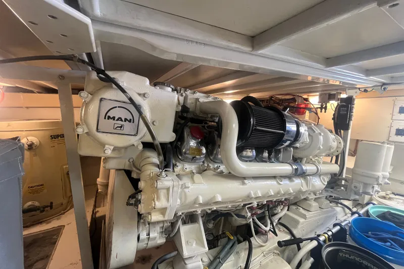 Slide: The Image of Engine room of a 1997 Post Sportfish boat featuring a MAN diesel engine. - 9