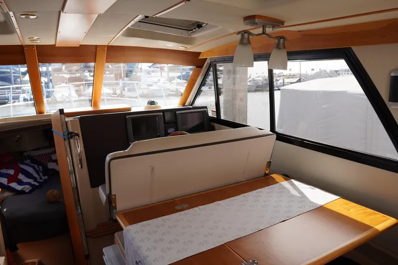 Slide: The Image of Interior of 2015 Cutwater 30 Command Bridge with dining area and helm station. - 10