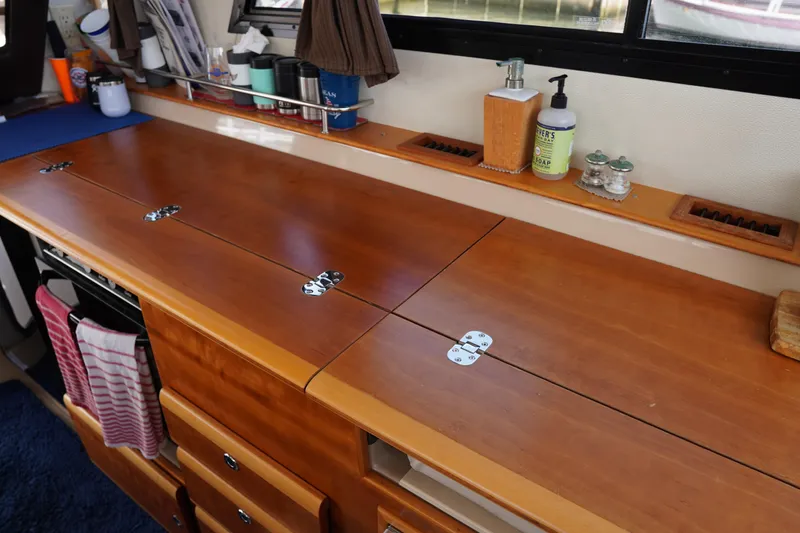 Slide: The Image of Interior of 2015 Cutwater 30 Command Bridge with wooden countertop and storage. - 12