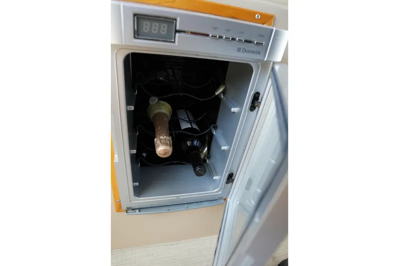 Slide: The Image of Wine cooler inside 2015 Cutwater 30 Command Bridge, featuring a digital temperature display. - 13