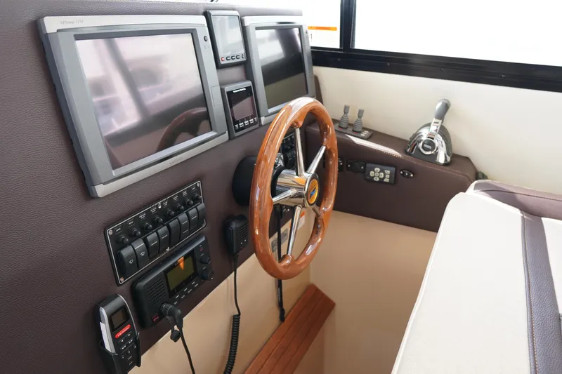 Slide: The Image of 2015 Cutwater 30 Command Bridge helm with navigation screens and controls. - 16