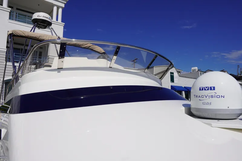 Slide: The Image of 2015 Cutwater 30 Command Bridge boat with Garmin and TracVision equipment, under clear blue sky. - 2