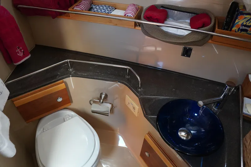 Slide: The Image of 2015 Cutwater 30 Command Bridge bathroom with modern sink and toilet setup. - 20