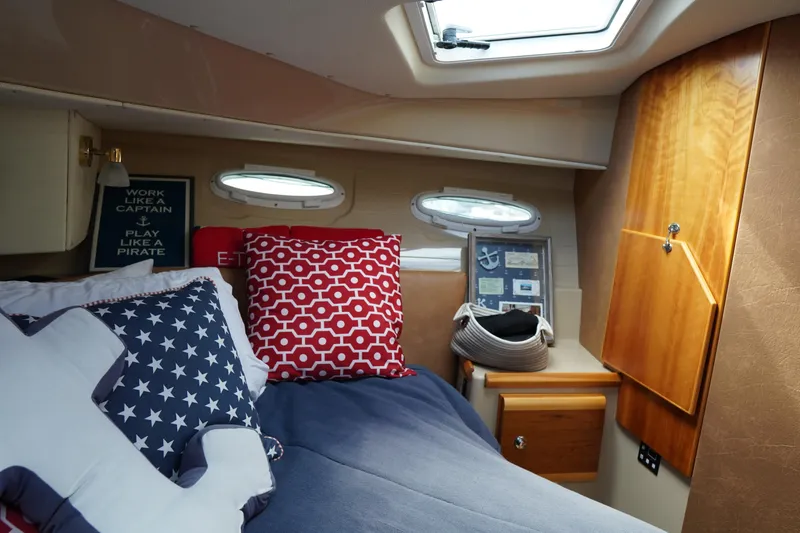 Slide: The Image of Cozy cabin interior of 2015 Cutwater 30 Command Bridge with nautical decor and bedding. - 22