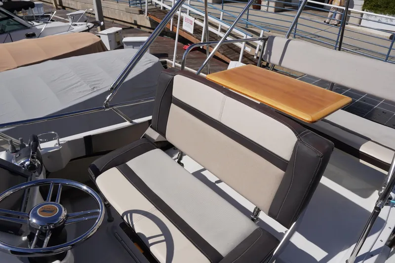 Slide: The Image of 2015 Cutwater 30 Command Bridge interior with steering wheel and seating area. - 26