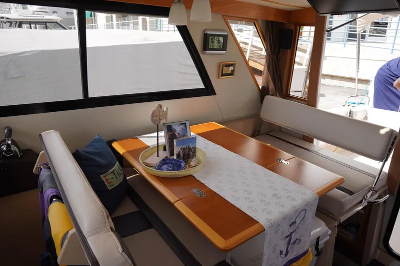 Slide: The Image of Interior of 2015 Cutwater 30 Command Bridge with dining area and nautical decor. - 9