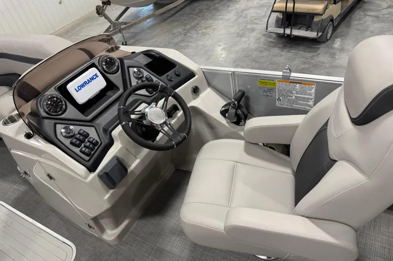 Slide: The Image of Captain's seat and control panel of 2022 Sylvan L 5 boat with Lowrance display. - 10