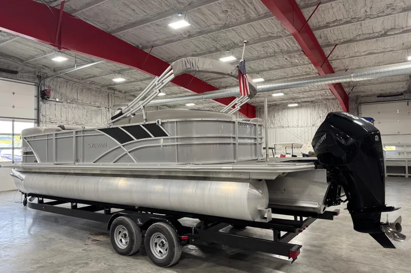 Slide: The Image of 2022 Sylvan L 5 pontoon boat on trailer in indoor storage facility. - 4