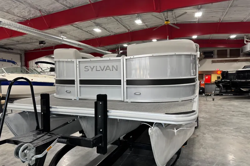 Slide: The Image of 2022 Sylvan L 5 pontoon boat in a showroom with red ceiling. - 5