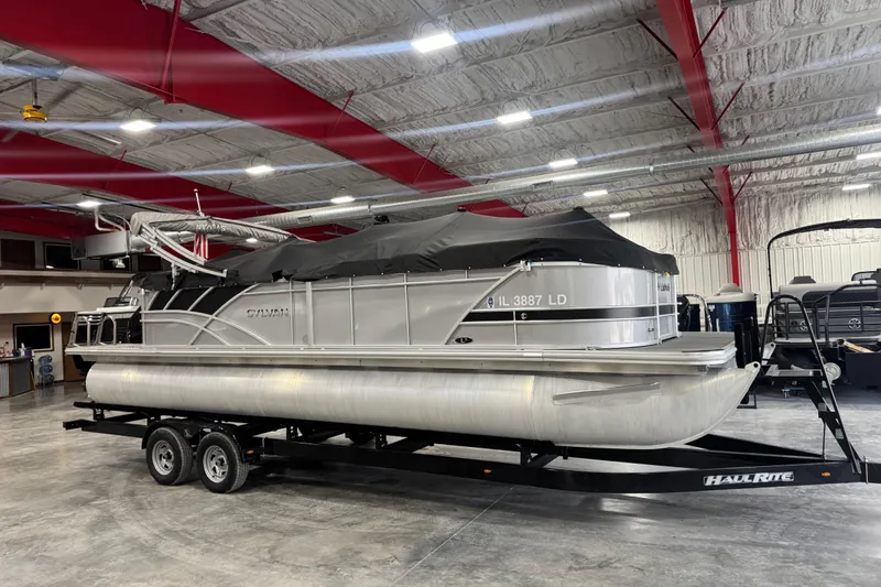 Slide: The Image of 2022 Sylvan L 5 pontoon boat on trailer in indoor storage facility. - 6