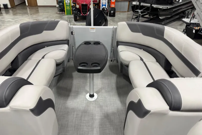 Slide: The Image of Interior of 2022 Sylvan L 5 boat with gray seating and central table. - 9