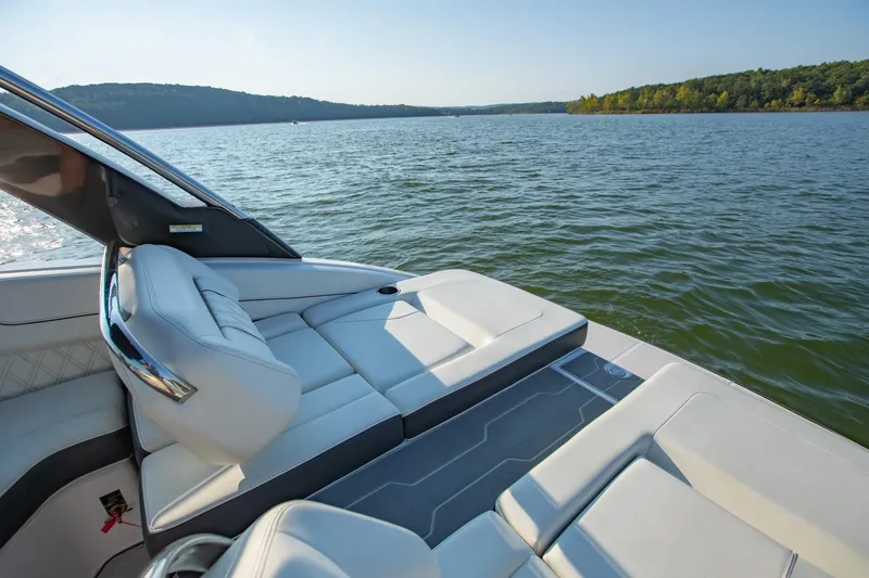 Slide: The Image of Luxurious 2020 Regal LS6 boat interior with white seating on a serene lake. - 10