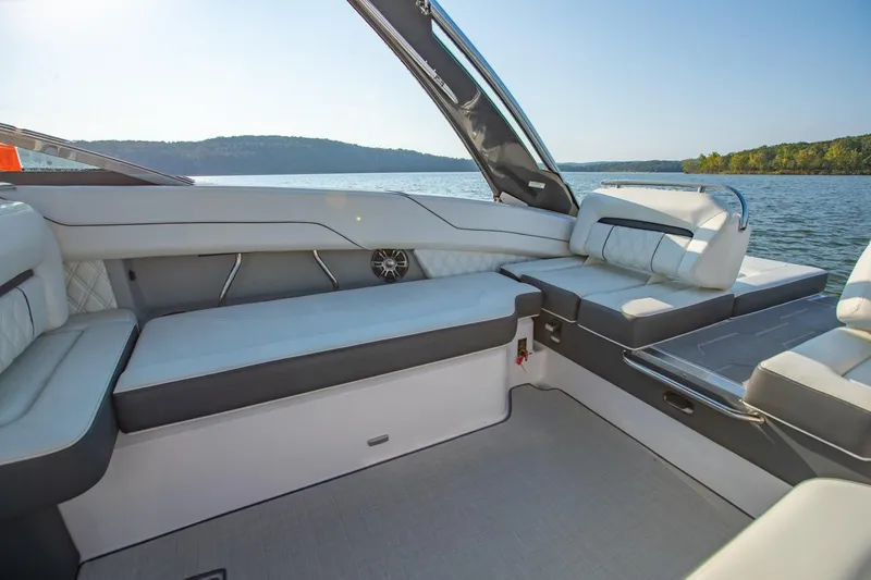 Slide: The Image of Luxurious interior of 2020 Regal LS6 boat with comfortable seating on a serene lake. - 12