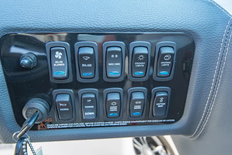 Slide: The Image of Control panel of a 2020 Regal LS6 boat with various function switches. - 20