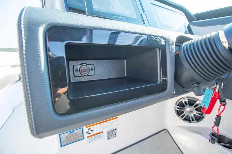 Slide: The Image of Dashboard of 2020 Regal LS6 boat with storage compartment and control panel. - 22