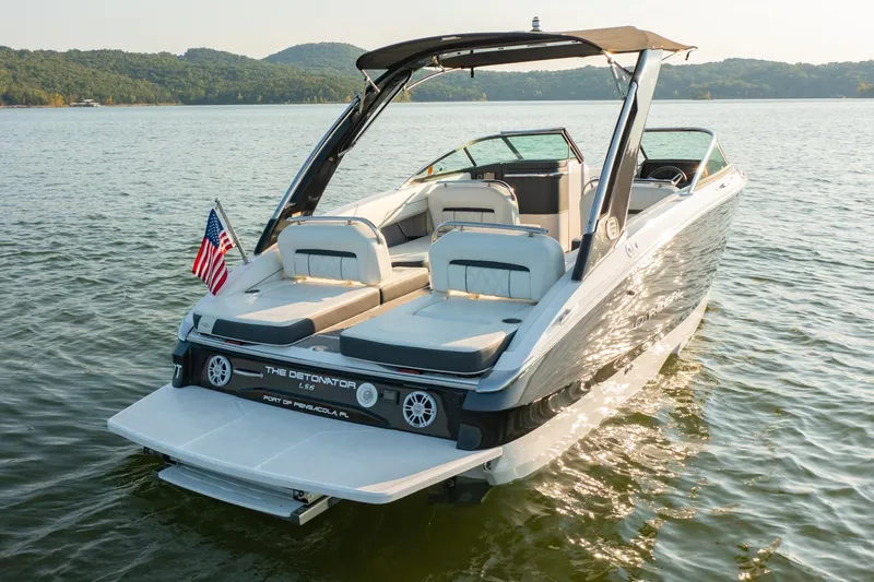 Slide: The Image of 2020 Regal LS6 boat on a lake with American flag, sunny day. - 3
