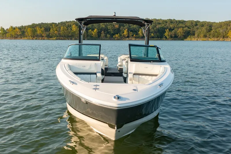 Slide: The Image of 2020 Regal LS6 boat on a serene lake with forested shoreline. - 5