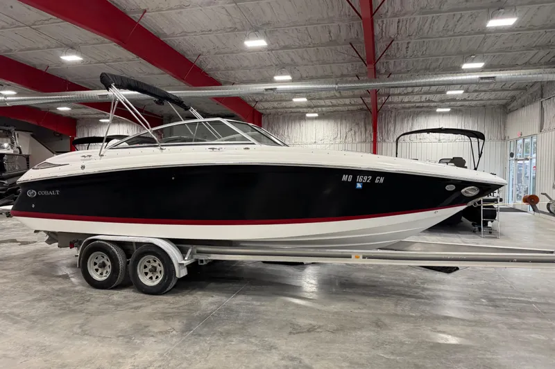 The Image of 2008 Cobalt 232 boat on trailer in indoor showroom setting. - 1