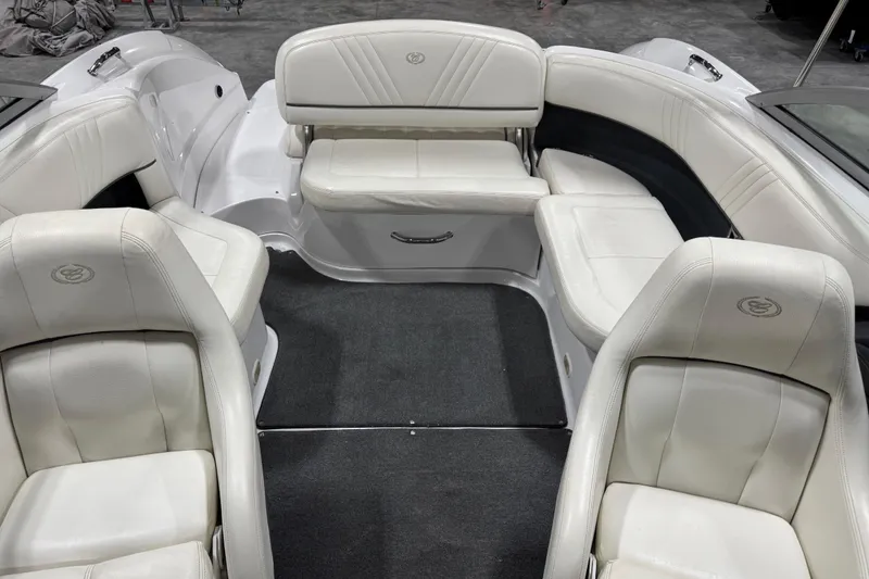 Slide: The Image of Interior of a 2008 Cobalt 232 boat with white leather seating and carpeted floor. - 10