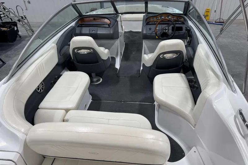 Slide: The Image of 2008 Cobalt 232 boat interior with white seating and modern dashboard. - 6