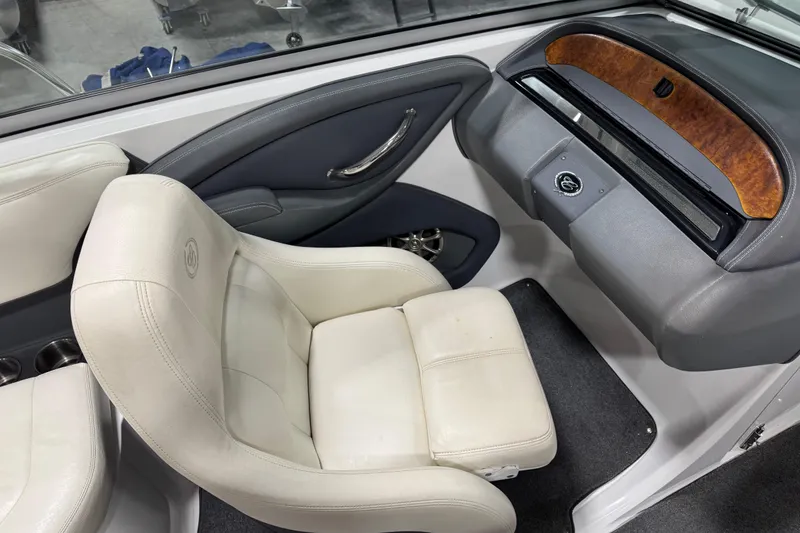 Slide: The Image of Interior of a 2008 Cobalt 232 boat featuring white leather seating and wood accents. - 7