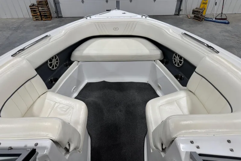 Slide: The Image of 2008 Cobalt 232 boat interior with white seating and carpeted floor. - 9