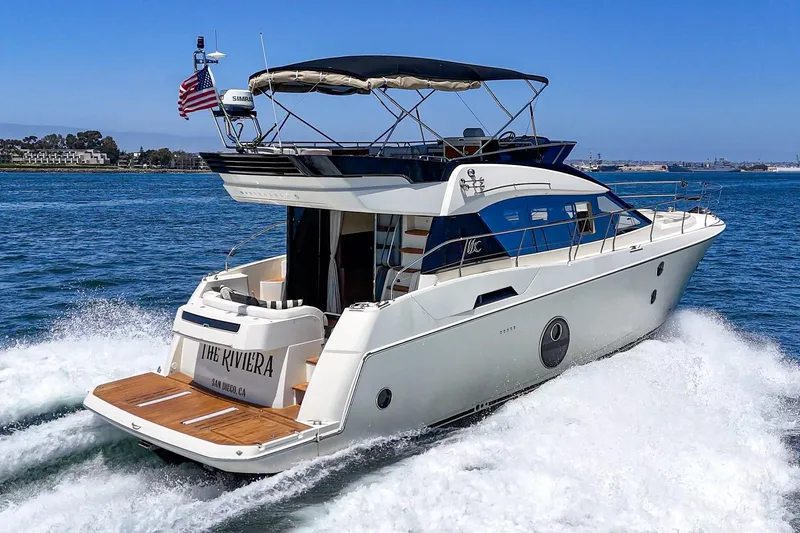 Slide: The Image of 2017 Monte Carlo MC5S yacht cruising on open water, rear view. - 12