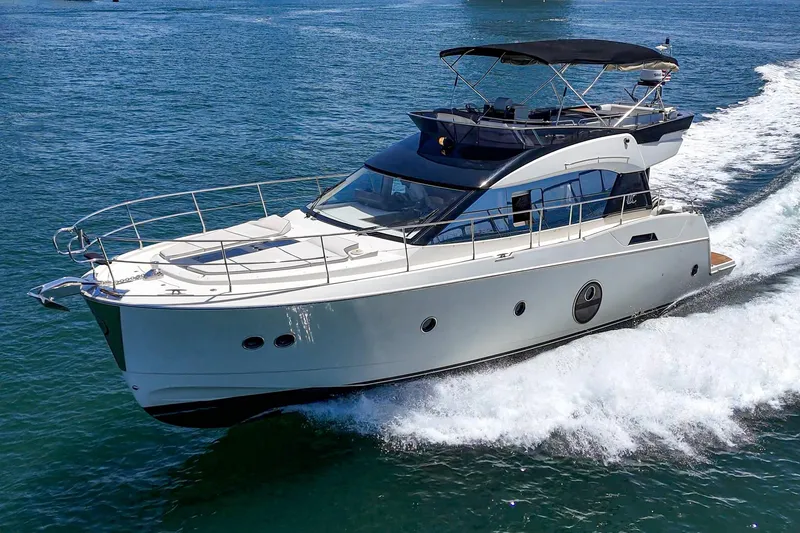 Slide: The Image of 2017 Monte Carlo MC5S yacht cruising on open water, showcasing sleek design and luxury. - 14