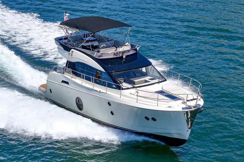 Slide: The Image of 2017 Monte Carlo MC5S yacht cruising on open water, showcasing sleek design and luxury features. - 2