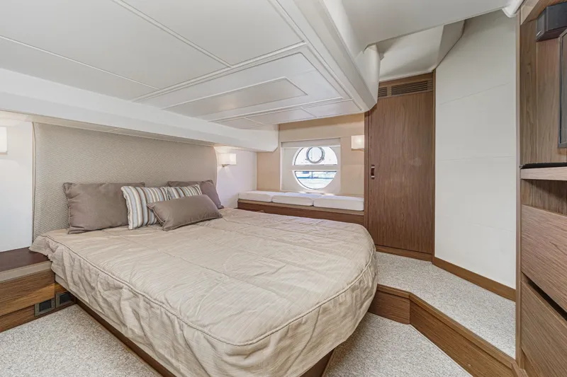 Slide: The Image of Luxurious 2017 Monte Carlo MC5S yacht bedroom with elegant decor and circular window. - 47
