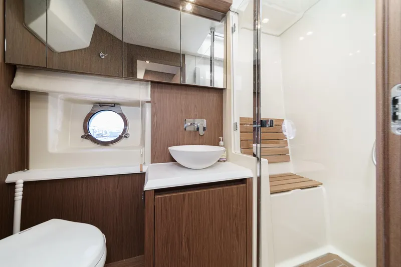 Slide: The Image of Luxurious 2017 Monte Carlo MC5S yacht bathroom with modern fixtures and wooden accents. - 50
