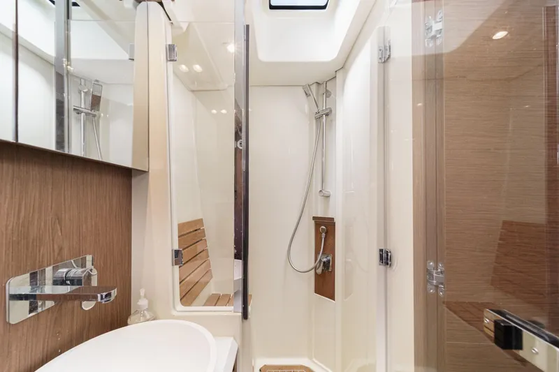 Slide: The Image of Luxurious bathroom in 2017 Monte Carlo MC5S yacht with modern shower and wooden accents. - 51