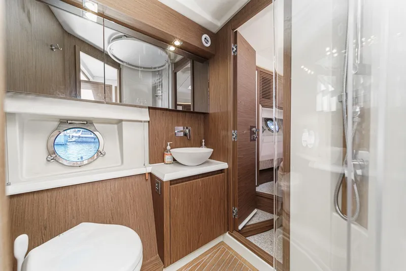 Slide: The Image of Luxurious 2017 Monte Carlo MC5S yacht bathroom with modern fixtures and porthole view. - 55