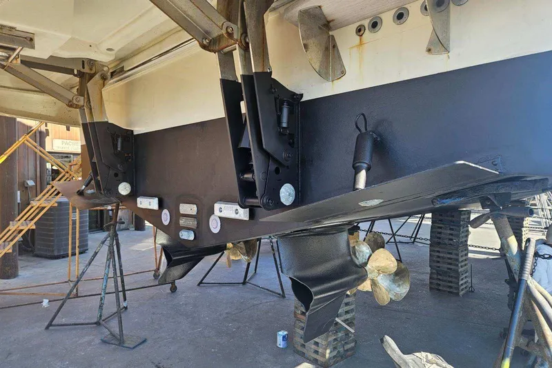 Slide: The Image of 2017 Monte Carlo MC5S yacht under maintenance, showcasing propellers and hull structure. - 72