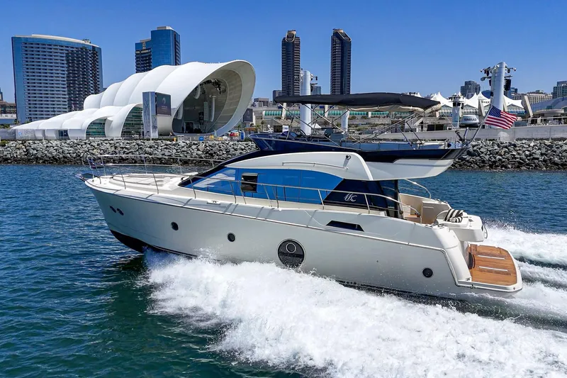 The Image of 2017 Monte Carlo MC5S yacht cruising near modern city skyline and waterfront architecture. - 0