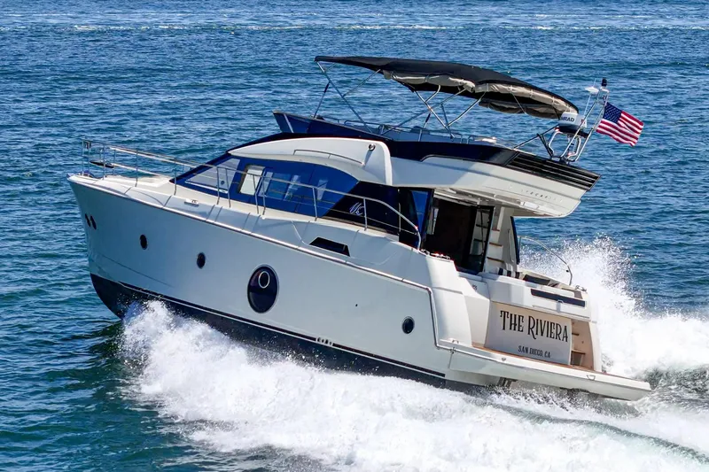 Slide: The Image of 2017 Monte Carlo MC5S yacht cruising on open water with American flag. - 11