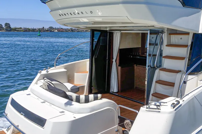 Slide: The Image of 2017 Monte Carlo MC5S yacht with open deck, luxurious interior, and scenic water view. - 28