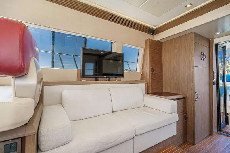 Slide: The Image of Luxurious 2017 Monte Carlo MC5S yacht interior with beige sofa and mounted TV. - 41
