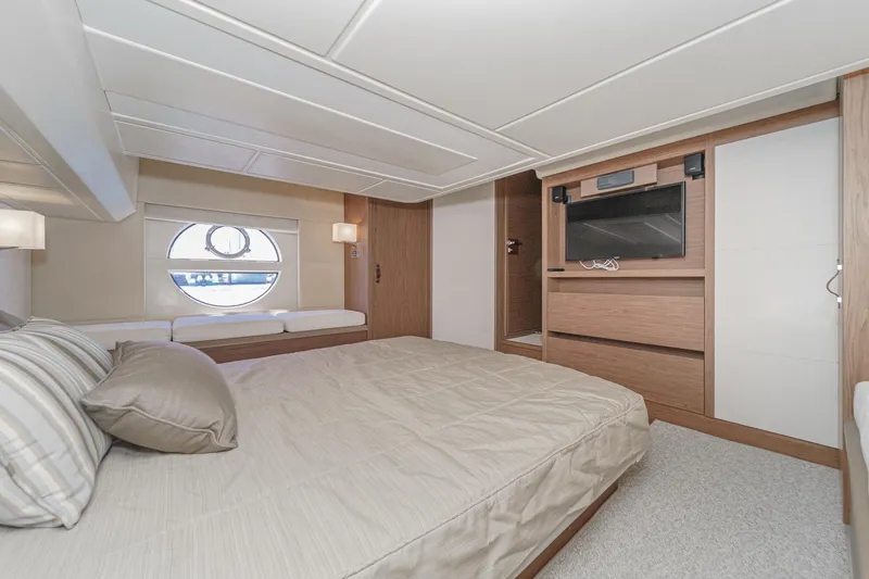 Slide: The Image of Luxurious 2017 Monte Carlo MC5S yacht bedroom with modern decor and circular window. - 48