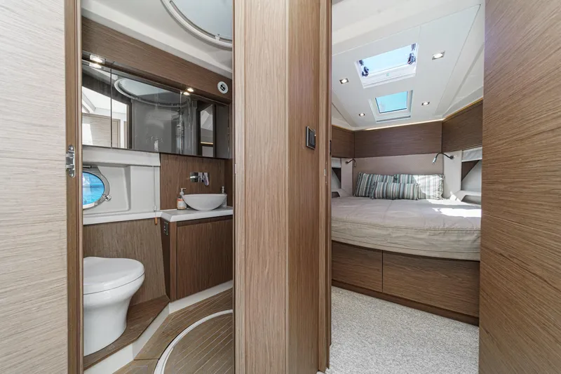 Slide: The Image of Luxurious interior of 2017 Monte Carlo MC5S yacht featuring bedroom and bathroom. - 54