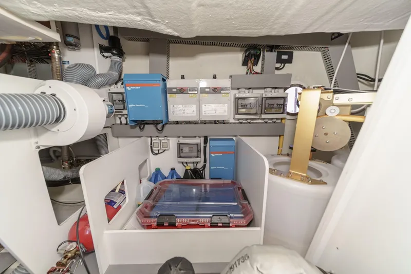 Slide: The Image of 2017 Monte Carlo MC5S engine room with electrical systems and storage compartments. - 68