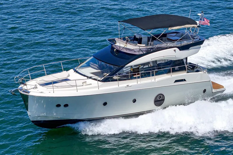 Slide: The Image of 2017 Monte Carlo MC5S yacht cruising on open water with American flag. - 7