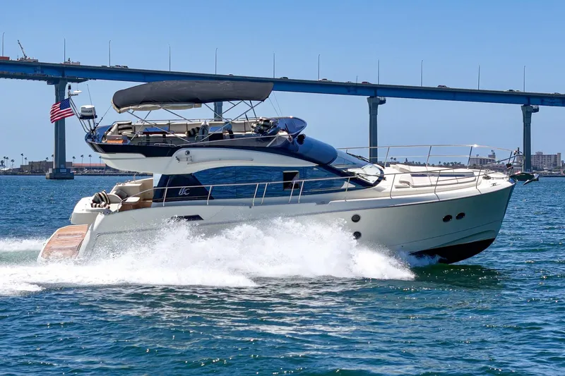 Slide: The Image of 2017 Monte Carlo MC5S yacht cruising under a bridge on a sunny day. - 9