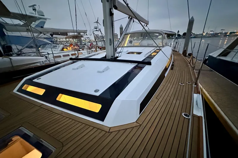 Slide: The Image of 2021 Beneteau Oceanis 55.1 yacht with illuminated deck at marina during dusk. - 16
