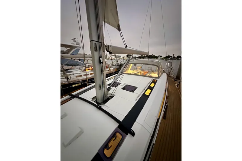 Slide: The Image of 2021 Beneteau Oceanis 55.1 sailboat docked, showcasing sleek deck design and modern features. - 17