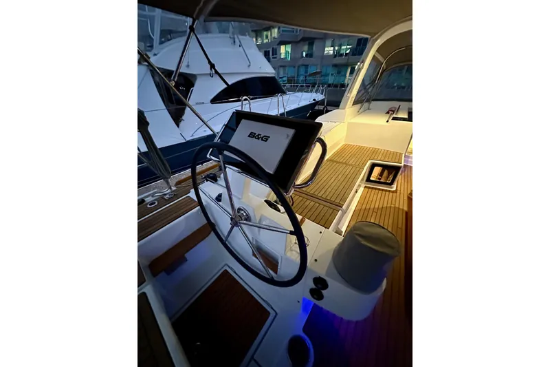 Slide: The Image of Cockpit of 2021 Beneteau Oceanis 55.1 yacht with steering wheel and navigation system. - 24